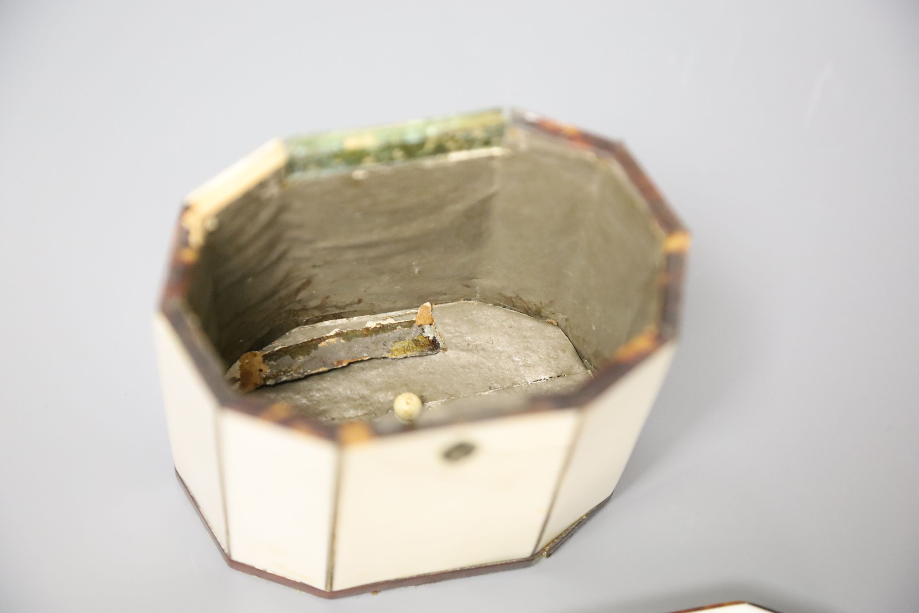 A George III octagonal ivory and tortoiseshell veneered tea caddy, height 10cm